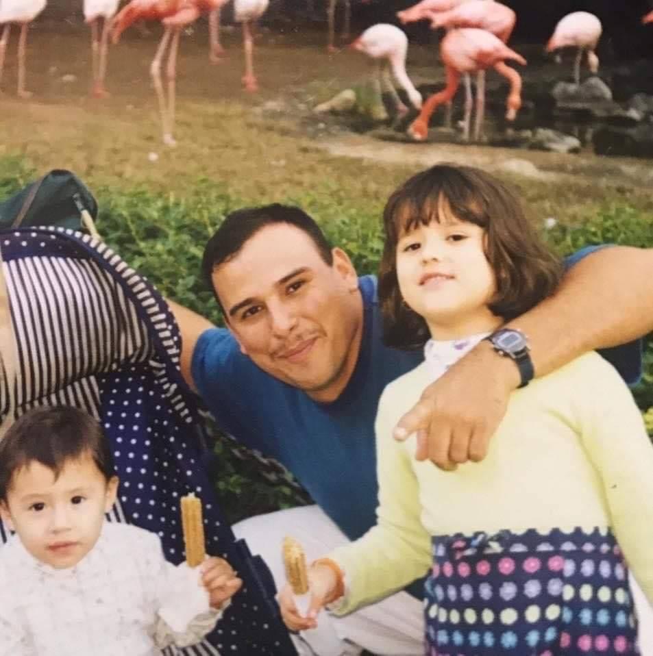An adult with two children outdoors